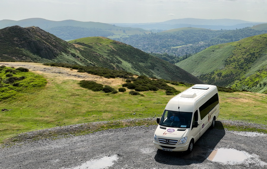 photograph of the Shuttle Bus parked on the Long Mynd with view of the hills