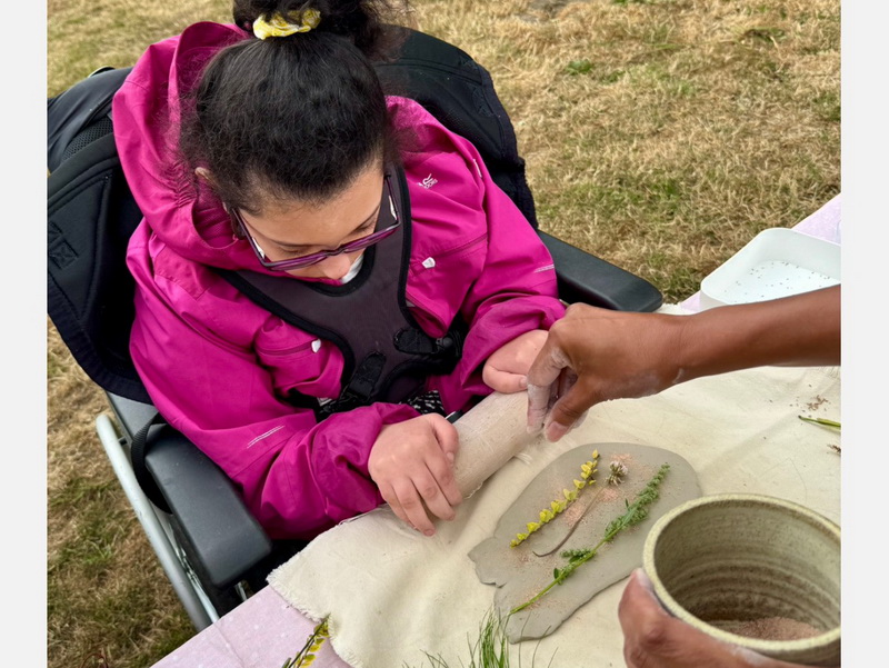 participant making her clay tile